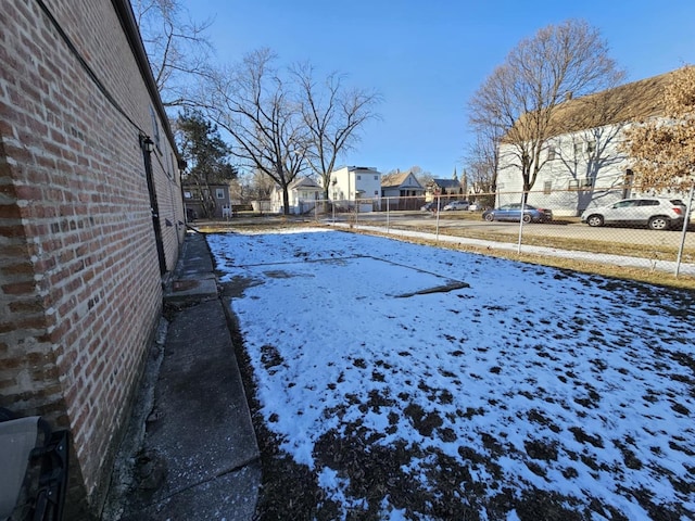 view of yard layered in snow