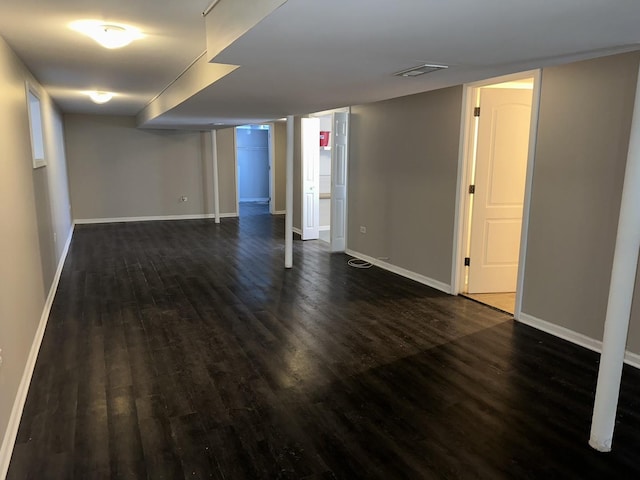 empty room featuring dark wood-type flooring