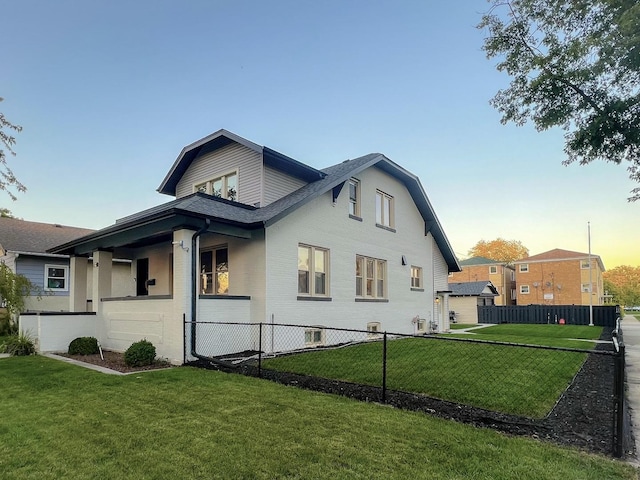 property exterior at dusk featuring a lawn