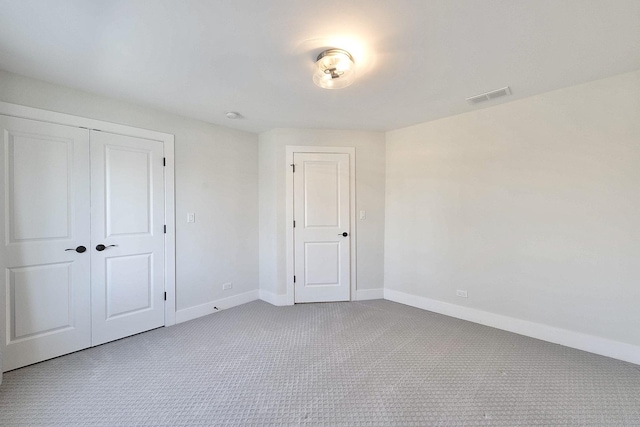 unfurnished bedroom with a closet and carpet floors