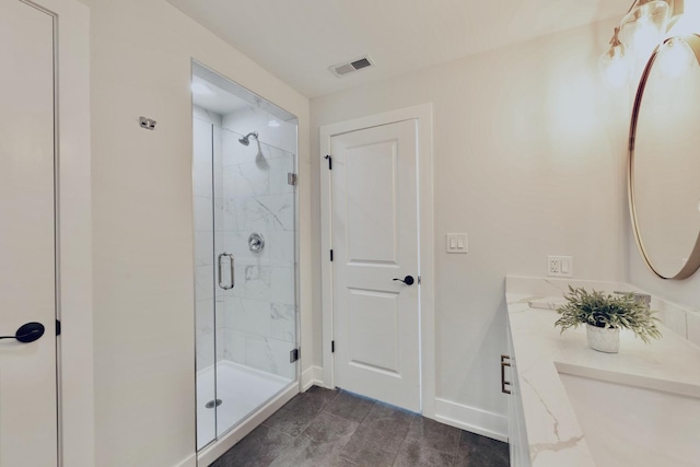 bathroom featuring a shower with door, tile patterned floors, and vanity