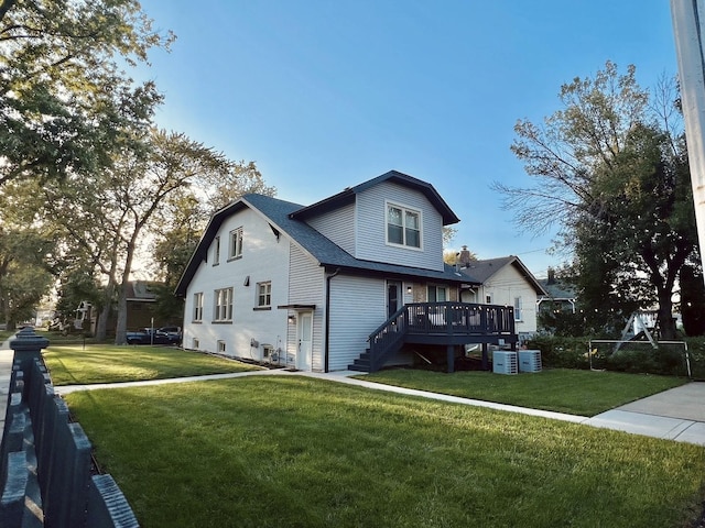 view of front of house with a deck and a front yard