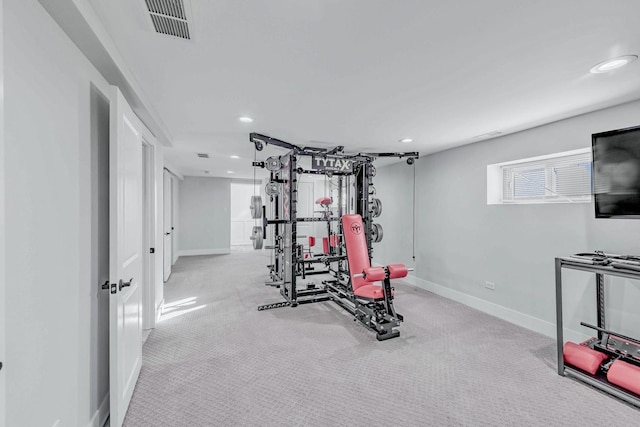 workout area featuring light colored carpet