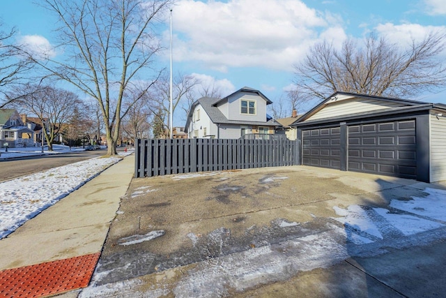 view of home's exterior with a garage and an outbuilding