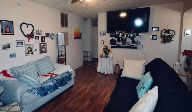 living room with dark wood-type flooring and ceiling fan