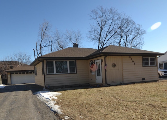 ranch-style home with a garage and a front lawn