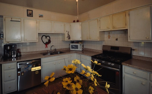 kitchen featuring tasteful backsplash, sink, dishwasher, and gas stove