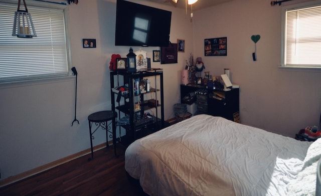 bedroom with dark hardwood / wood-style floors