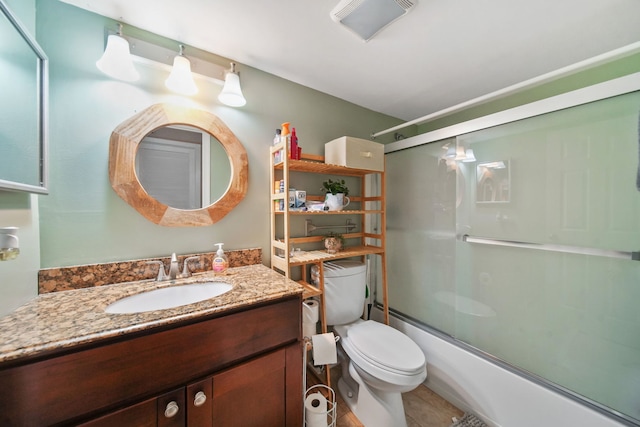 full bathroom featuring toilet, enclosed tub / shower combo, and vanity