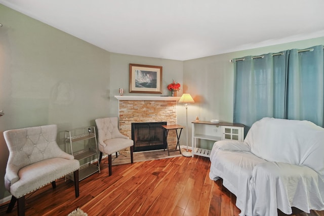 living area featuring a fireplace and hardwood / wood-style flooring