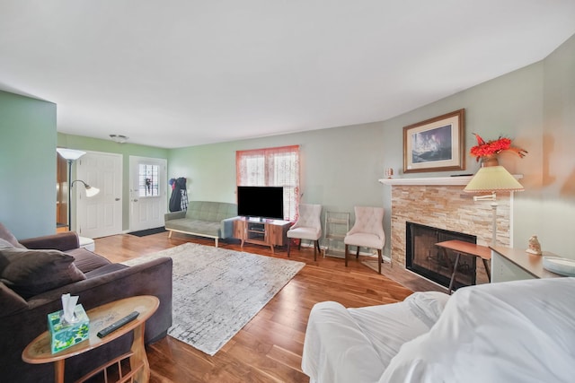 living room with wood-type flooring and a fireplace