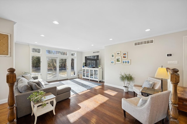 living room featuring crown molding and dark hardwood / wood-style floors