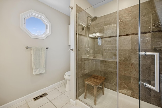 bathroom featuring an enclosed shower, tile patterned floors, and toilet