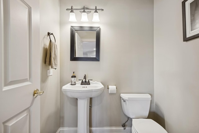 bathroom featuring sink and toilet