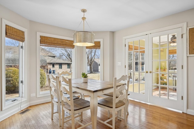 dining room featuring light hardwood / wood-style flooring and french doors