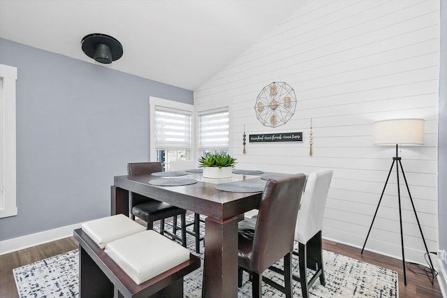 dining room featuring hardwood / wood-style floors and vaulted ceiling