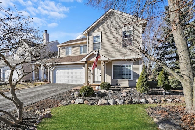 view of front of home featuring a garage and a front lawn