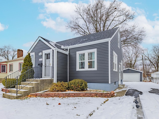 bungalow-style house featuring an outbuilding and a garage