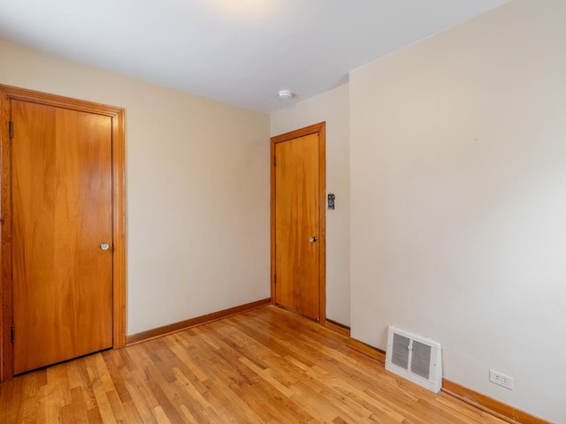 unfurnished room with light hardwood / wood-style floors