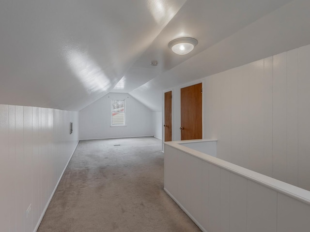 additional living space with light carpet and lofted ceiling