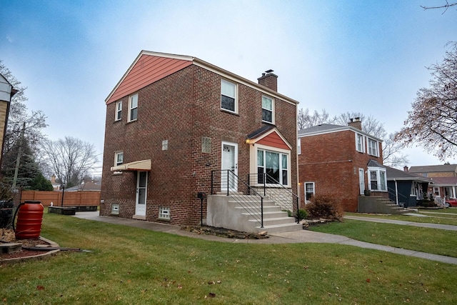 rear view of house with a lawn