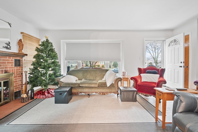 living room featuring a brick fireplace