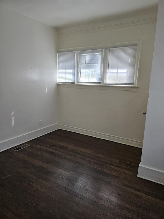 unfurnished room with plenty of natural light and dark hardwood / wood-style floors