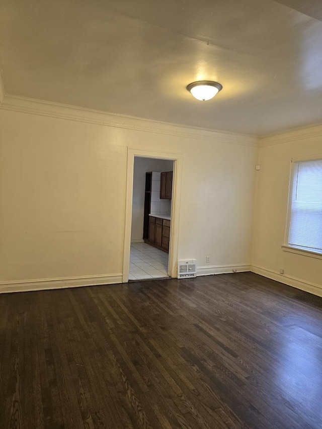 unfurnished room featuring ornamental molding and hardwood / wood-style floors