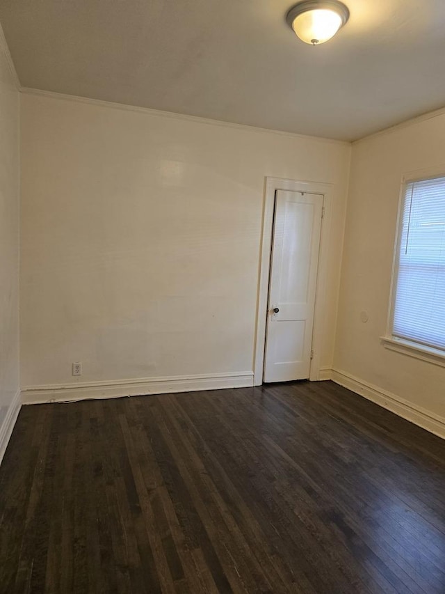 unfurnished room featuring crown molding and dark hardwood / wood-style flooring