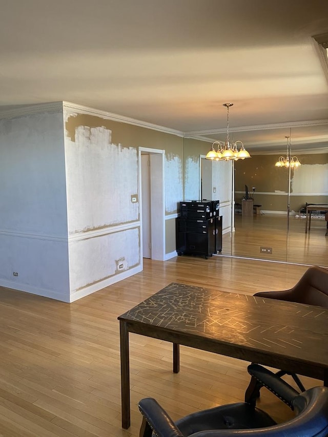 living room with a notable chandelier, crown molding, and wood-type flooring