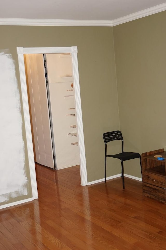 spare room featuring ornamental molding and hardwood / wood-style floors