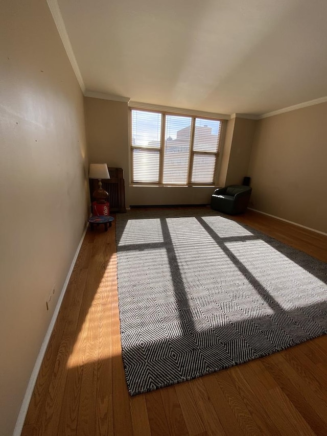 interior space featuring hardwood / wood-style flooring and ornamental molding