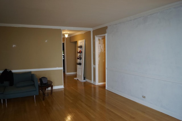 unfurnished room featuring hardwood / wood-style floors and ornamental molding