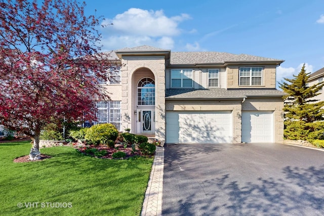 view of front of house with a front lawn and a garage