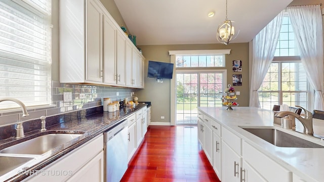 kitchen featuring white cabinetry, dishwasher, and sink