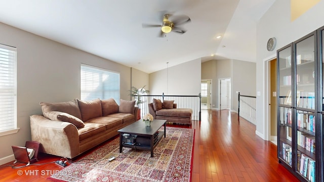 living room with ceiling fan, vaulted ceiling, and hardwood / wood-style flooring