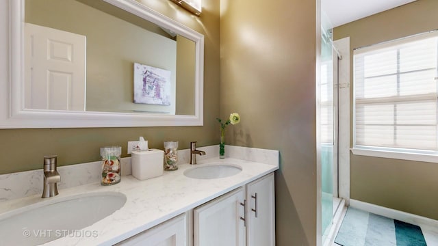 bathroom with vanity and a shower with door