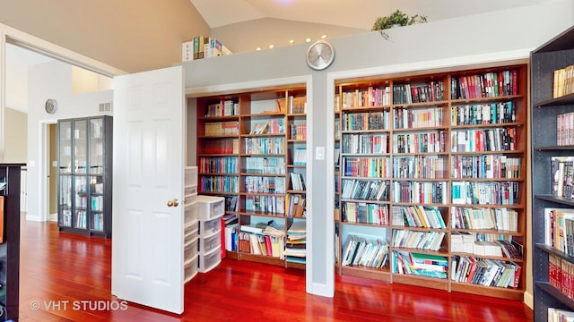 sitting room featuring vaulted ceiling and hardwood / wood-style flooring