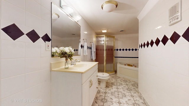 bathroom with toilet, vanity, tile walls, and a shower with shower door