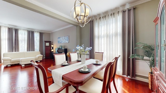 dining area featuring dark wood-type flooring, a notable chandelier, and crown molding