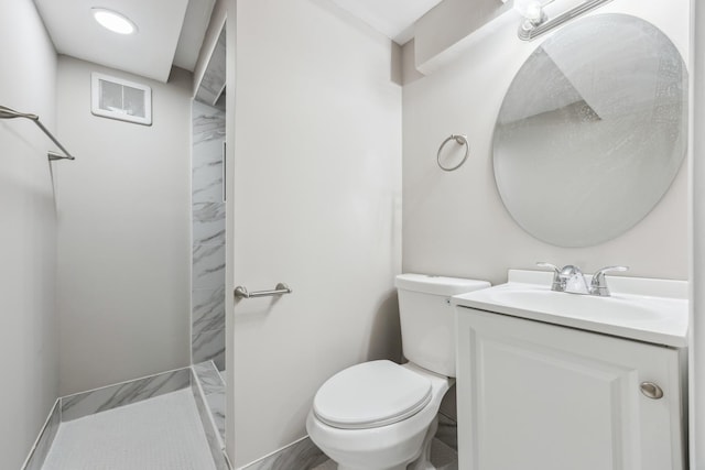 bathroom with vanity, toilet, and walk in shower