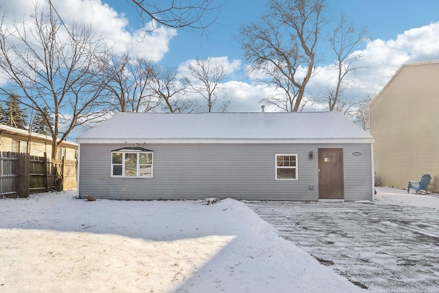 view of snow covered back of property