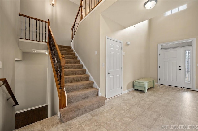 entryway featuring a towering ceiling