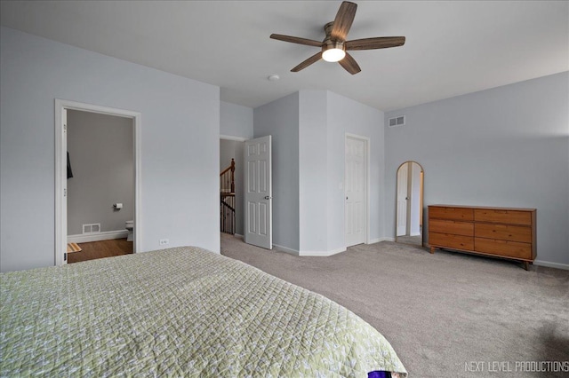 bedroom with carpet floors, ceiling fan, and ensuite bathroom