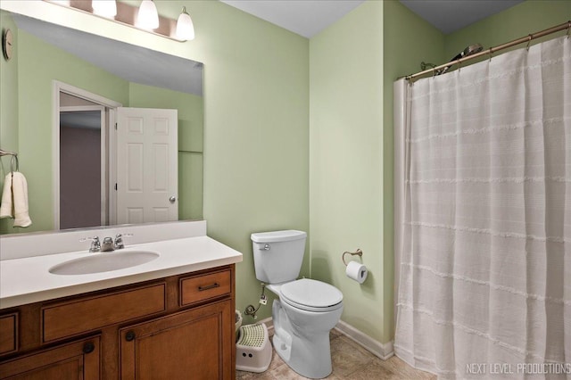 bathroom with vanity, tile patterned flooring, a shower with curtain, and toilet