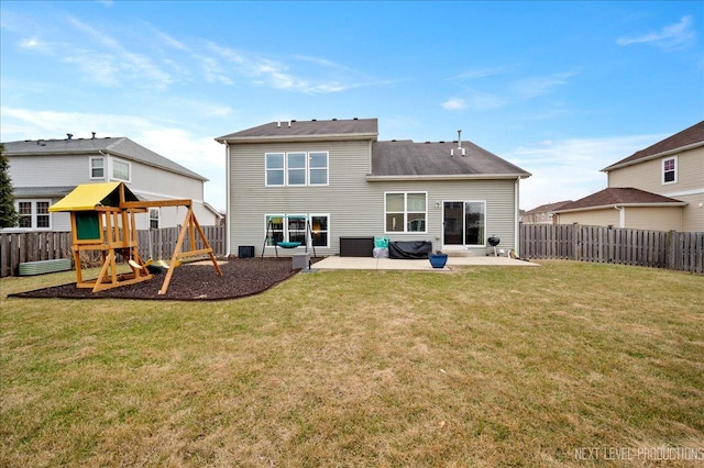 rear view of property with a yard, a playground, and a patio area