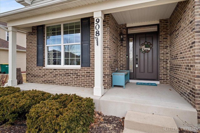 view of exterior entry with covered porch