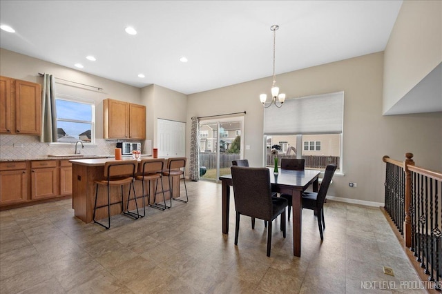 dining room featuring sink and a chandelier