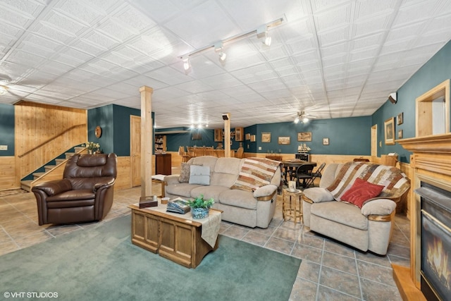 tiled living room featuring wooden walls