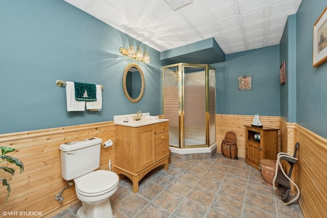 bathroom with walk in shower, vanity, and wood walls